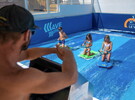 Camping avec simulateur de vagues en bord de mer dans les Landes machine à surf bouées tractées le surf et le bodyboard le kneeboard une vague douce ou pentue - enfants s'amusant à la surface de l'eau avec maître nageur réserver un séjour camping à prix réduit