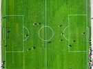 Camping avec terrain de football dans les Landes (1) vue drone du dessous d'un terrain de foot sur gazon avec personnes disputant un match