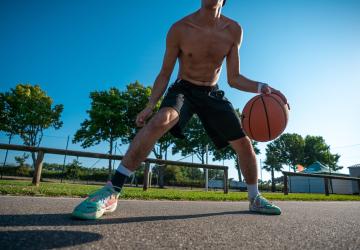 Joueur de basket sur le terrain de sports du camping 5 étoiles Le Vieux Port dans les Landes