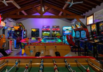 Salle de jeux et d’arcade moderne située dans un camping en bord de mer dans les Landes, équipée de bornes d’arcade, de billards, de baby-foot et de jeux interactifs pour petits et grands, offrant un espace convivial et divertissant à quelques pas de l’océan.