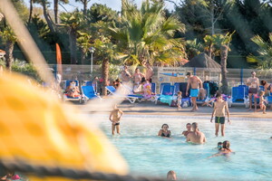 Camping avec piscine à vagues dans les Landes 5-etoiles-vieux-port-lande(4) derrière le filet et la bouée de sauvetage avec personne qui profitent de leur moment dans le parc aquatique à thème XXL