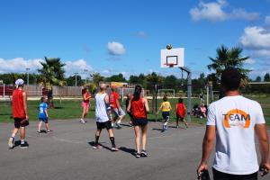Camping avec terrain de basket dans les Landes en bord de mer Groupe de jeunes jouant au basket au camping nature