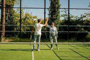 Deux personnes d'entreprise sur le terrain de padel pour renforcer les liens d'équipe et améliorer la confiance dans leur société avec leurs collègues
