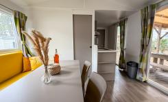 Intérieur chaleureux d’un mobil home avec salon et cuisine équipée au camping dans les Landes